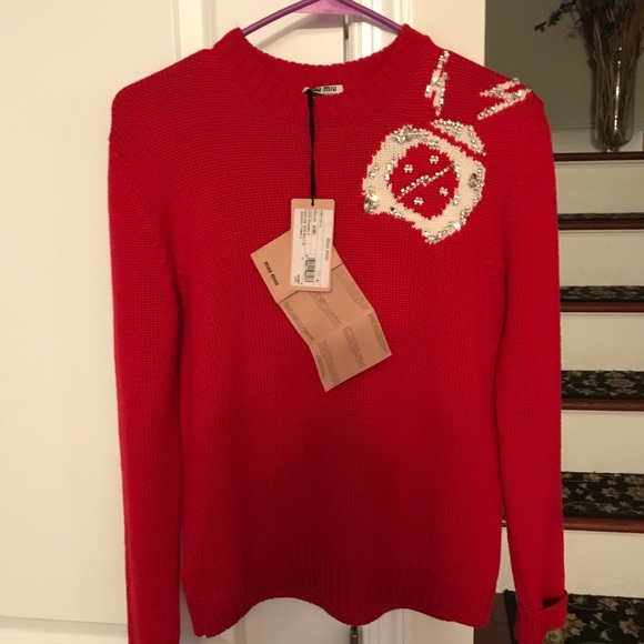 Red sweater with arrow/heart print in front